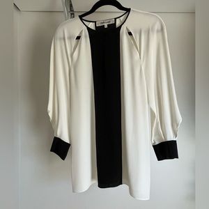 Silk blouse with cut outs in off-white and black